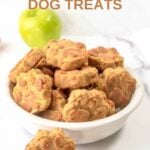 Homemade paw-shaped apple carrot dog treats in and beside a bowl and an apple behind it.