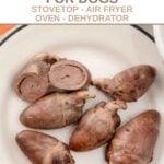 Cooked chicken hearts for dogs on a plate.
