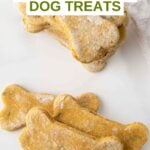 Homemade dog treats made with mint and parsley on a marble surface.