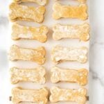 Bone-shaped homemade mint and parsley dog treats on a long platter.