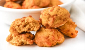 Several air fryer sweet potato egg bites for dogs and one broken in half.