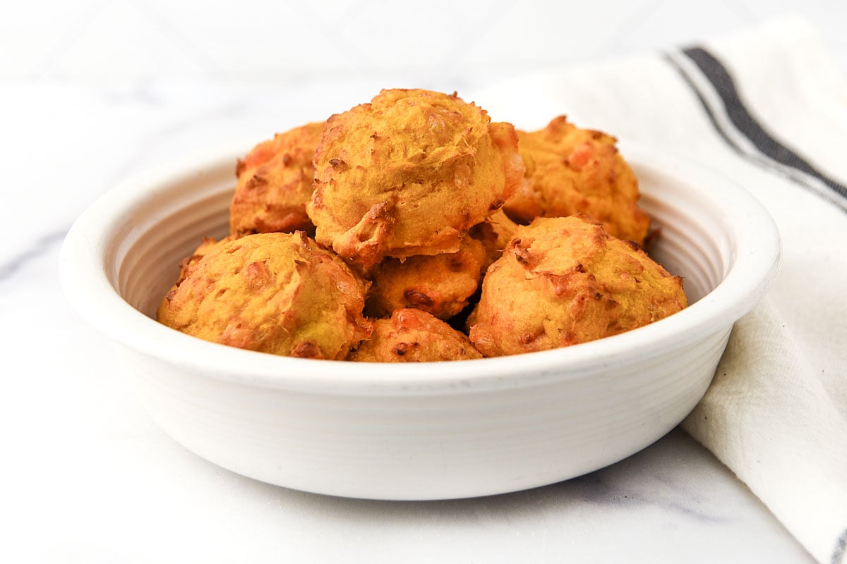 Cheesy air fryer sweet potato egg bites made for dogs piled in a dog bowl.