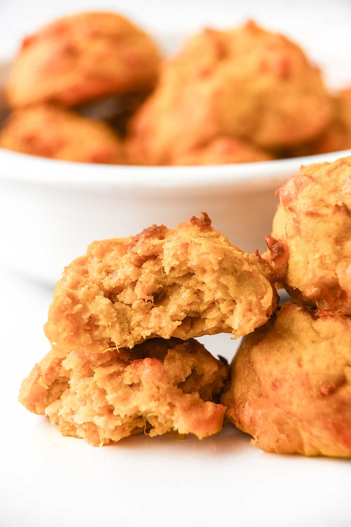 Cheesy air fryer sweet potato egg bites for dogs stacked and in a bowl.