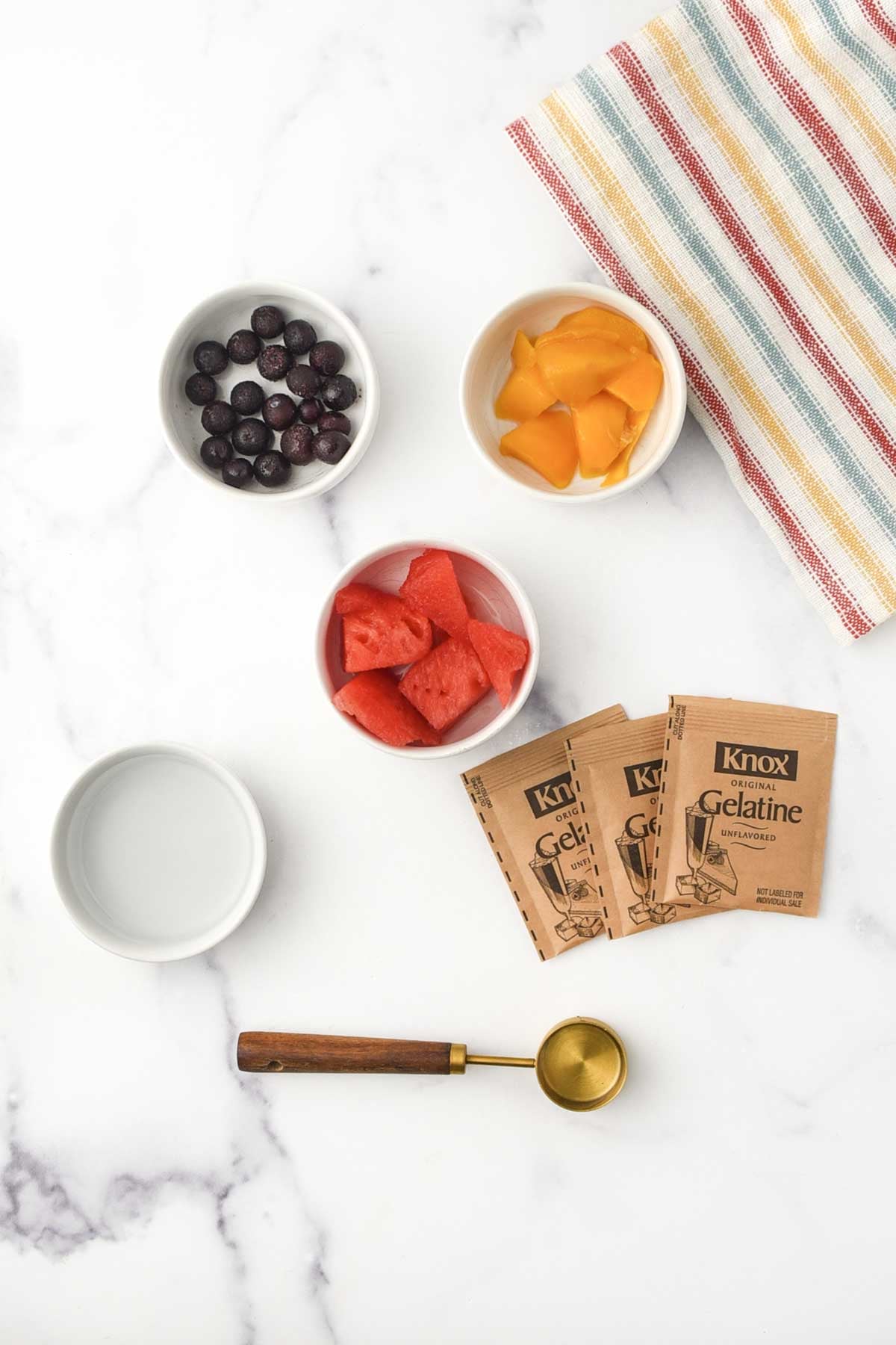 Blueberries, mango, watermelon, gelatin packets, and water.