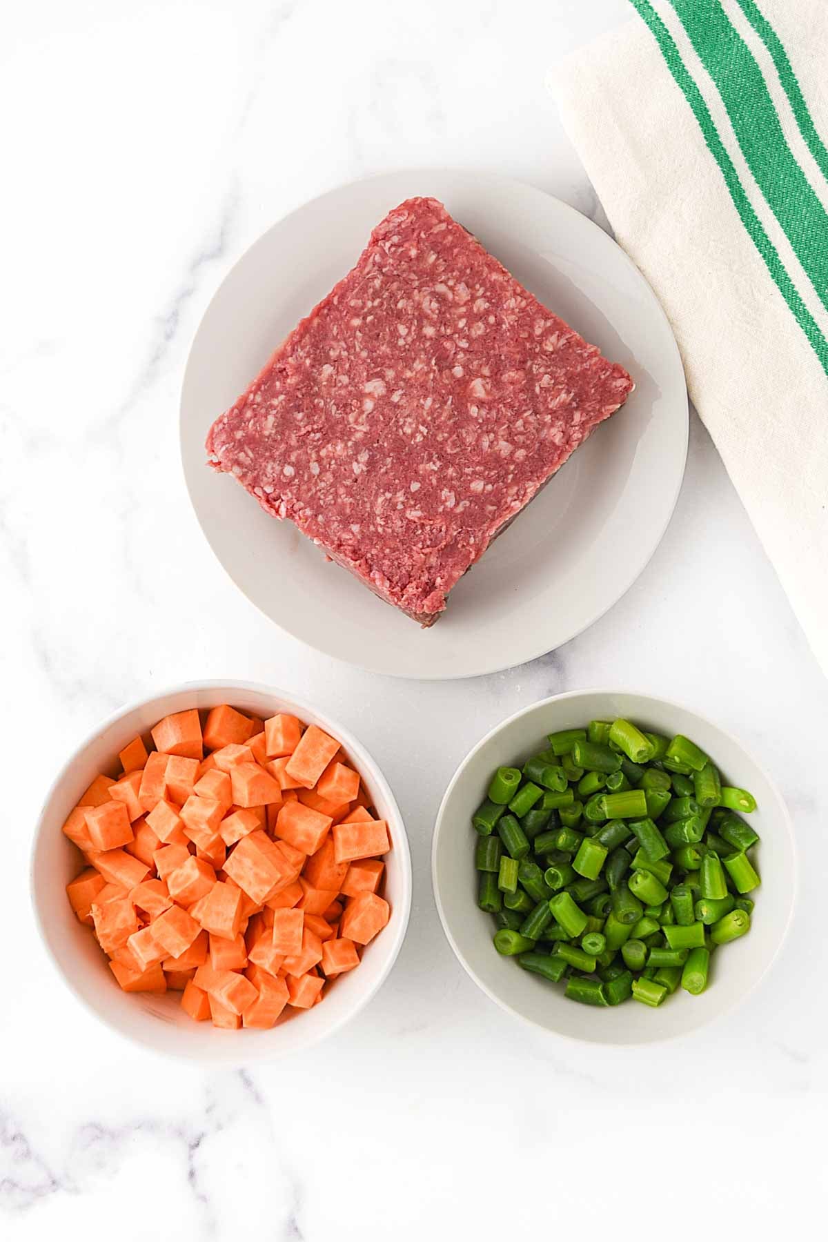 Ground lamb, sweet potato cubes, and green beans.