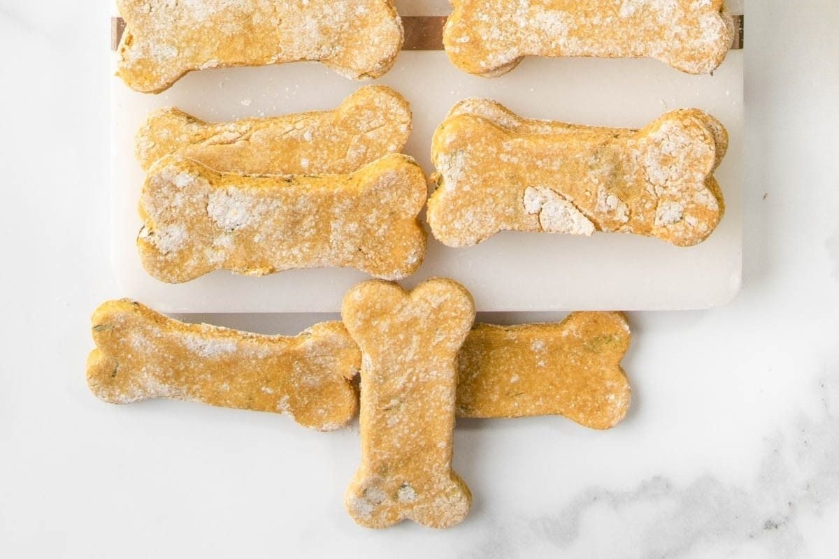 Homemade mint and parsley dog treats on and beside a platter.