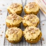 Homemade pumpkin pupcakes with pumpkin yogurt frosting topped with crushed dog treats.