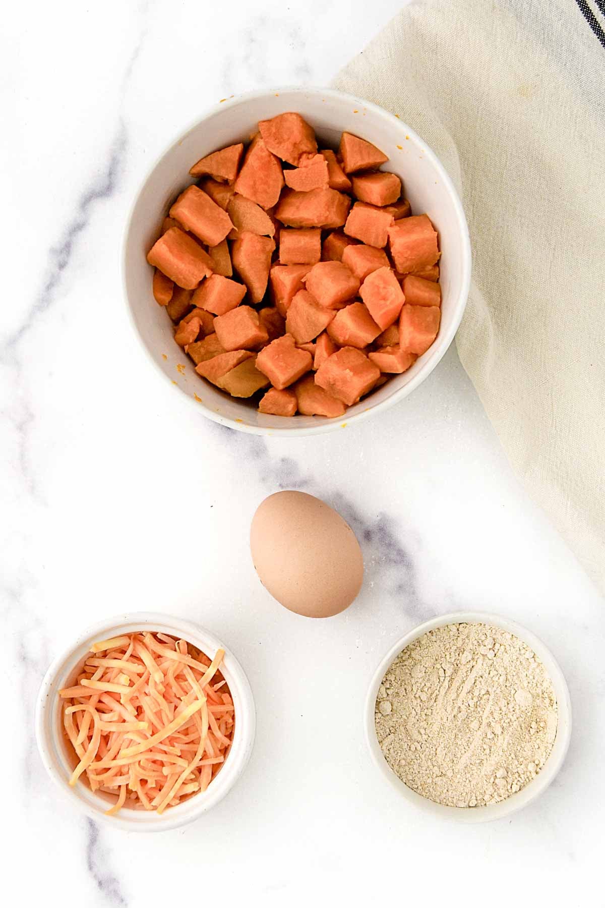 Sweet potato cubes, shredded cheese, egg, and oat flour.