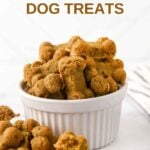 Homemade anchovy dog treats in a bowl and a few next to it.