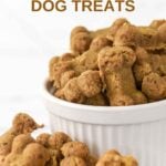 Homemade bone-shaped anchovy dog treats in a bowl and scattered beside it.