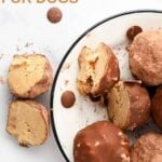 No-bake peanut butter carob truffles for dogs on a plate and one cut in half beside it.
