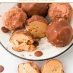 Homemade peanut butter carob truffles for dogs on a plate and some cut in half.