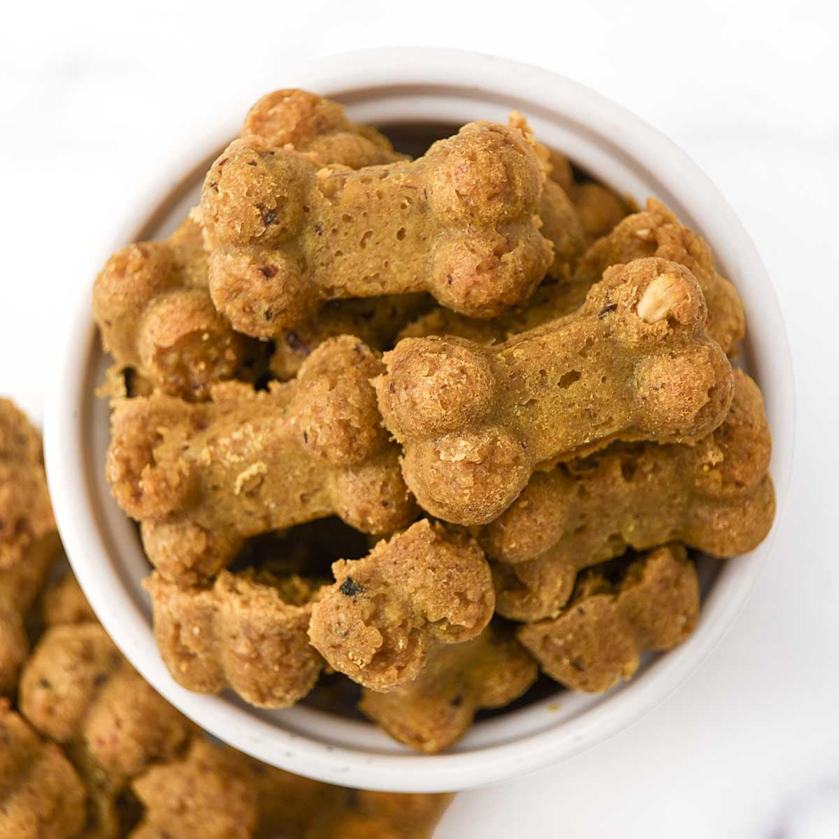 A bowl of bone-shaped homemade anchovy dog treats.