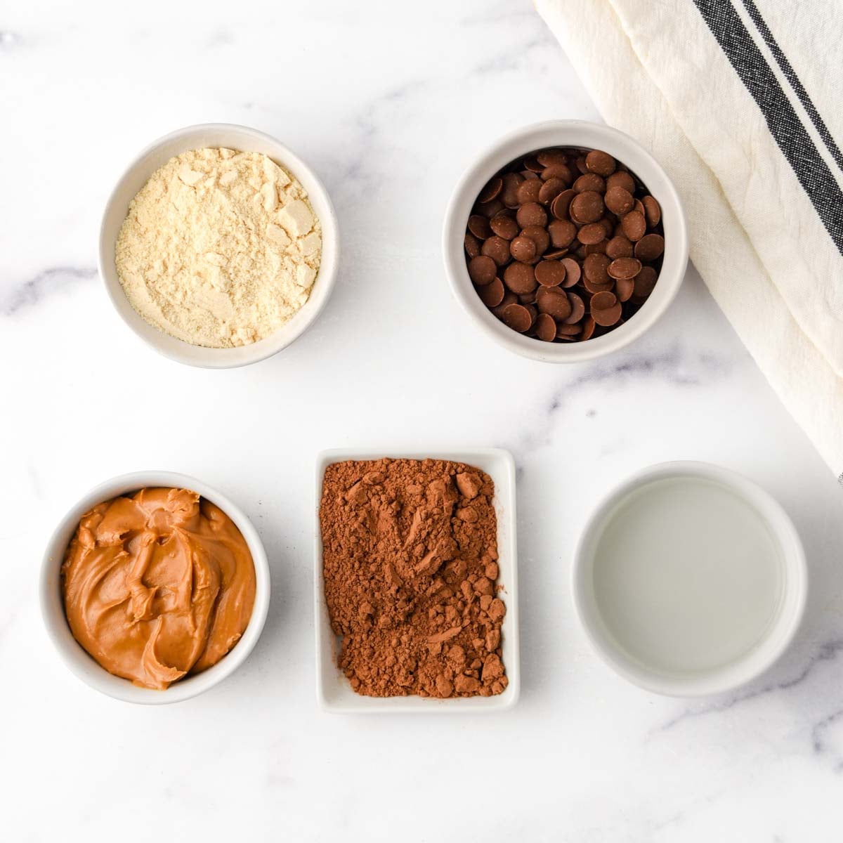 Peanut butter, coconut oil, coconut flour, carob powder, and carob chips.