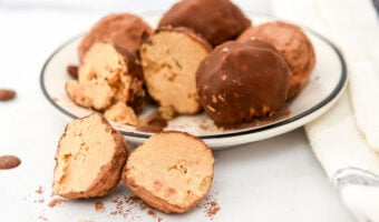 Homemade truffles for dogs made with peanut butter and carob on a plate.