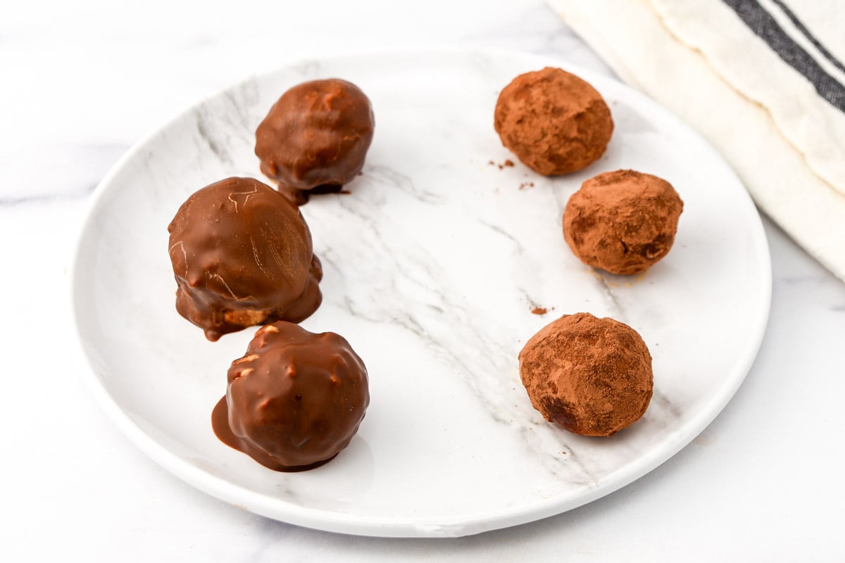 Homemade peanut butter truffle candy with carob coating made for dogs on a plate.